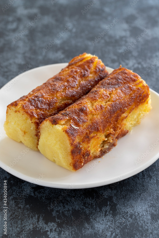 Cheese dessert on a dark background. Traditional Middle Eastern cuisine flavors. Cheese halva. Local name peynir helvası yada peynir tatlısı Cheese dessert on a dark background. Traditional Middle Eastern cuisine flavors. Cheese halva. Local name peynir helvası yada peynir tatlısı