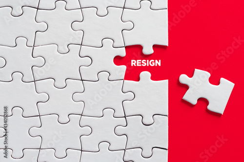 The word resign on missing puzzle piece. Resignation or to quit job