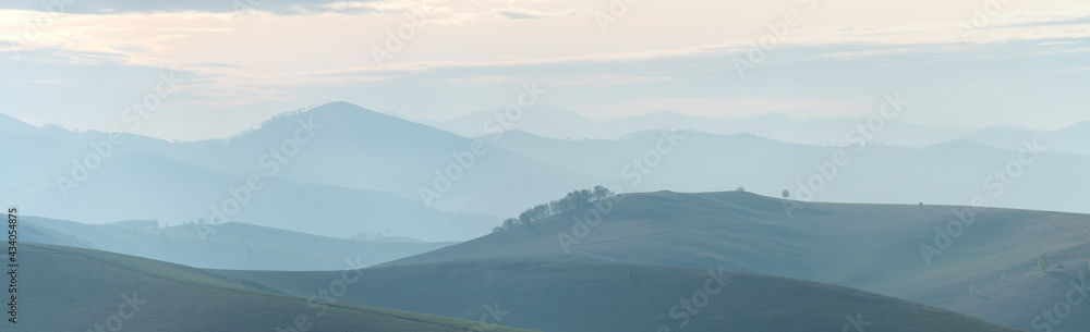 Mountains and hills in the morning haze, panoramic view