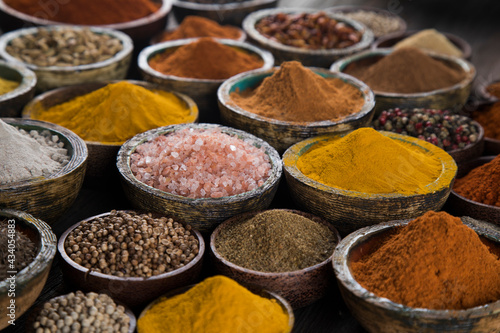 Spices on wooden bowl background