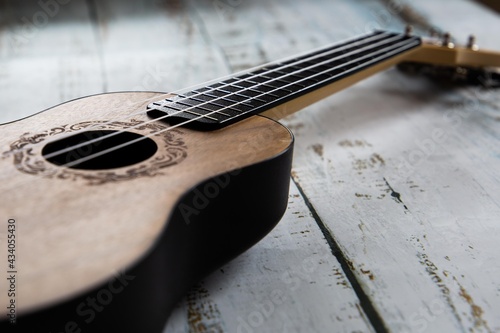 
Wooden ukulele on a light background close up
