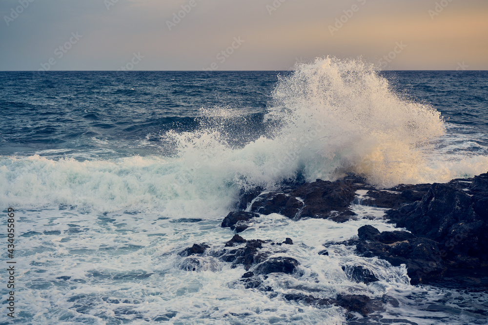 Splashes from the waves bumping against the rocky shore