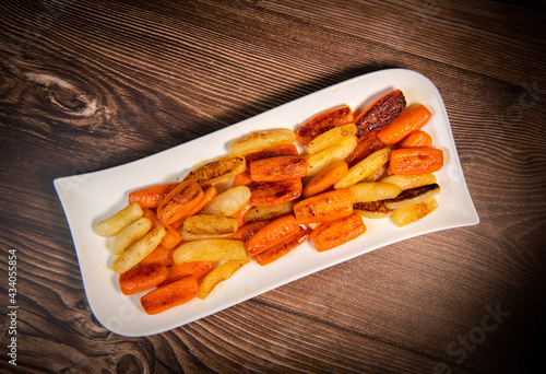 Chicken Hunter recipe with glazed root vegetables, carrot, turnip with its mushroom sauce deglazed in white wine and wet with the chicken stock photo