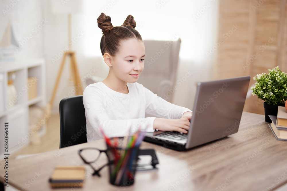 distance education concept - cute school girl using laptop at home distance education concept - cute school girl using laptop at home