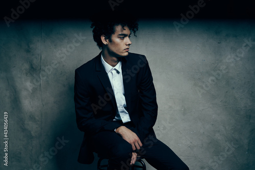 business man in a suit sitting on a chair fashion modern style Professional