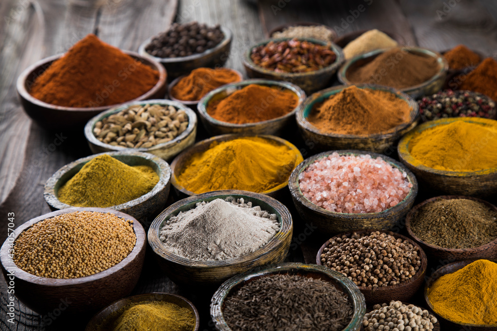 Spices on wooden bowl background