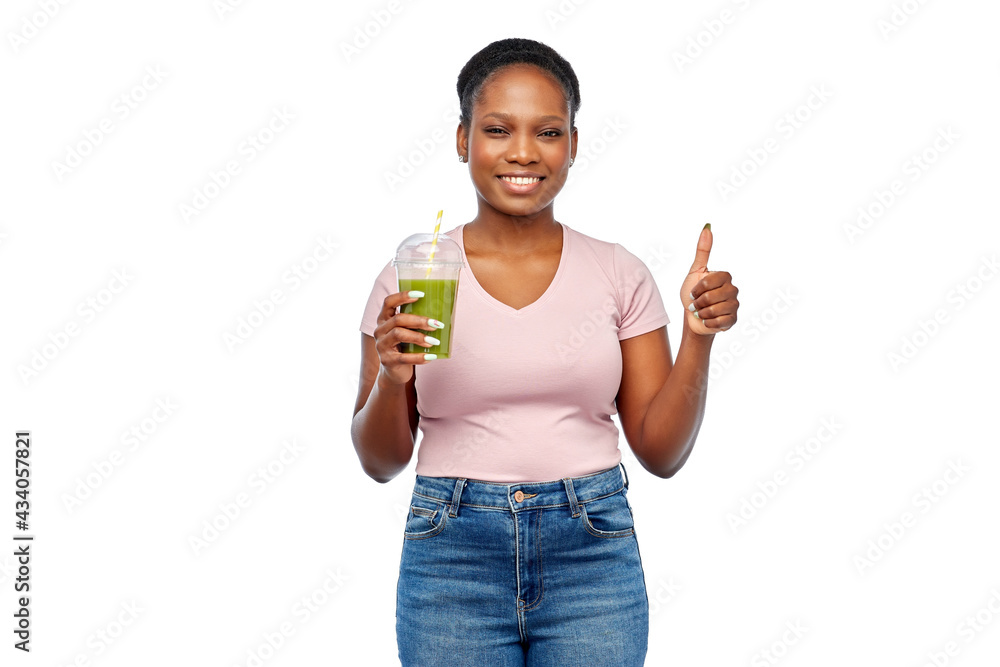 diet, healthy eating and detox concept - happy smiling young african american woman drinking green vegetable juice or smoothie from plastic cup with paper straw over white background diet, healthy eating and detox concept - happy smiling young african american woman drinking green vegetable juice or smoothie from plastic cup with paper straw over white background