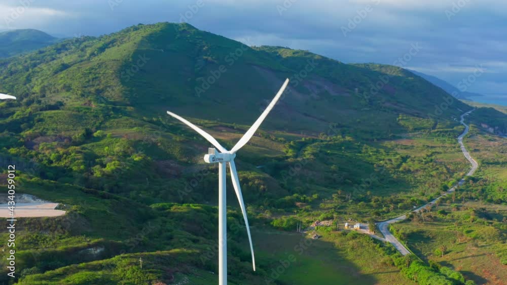 Row of wind turbine spinning Larimar coast in Dominican Republic. Aerial circling