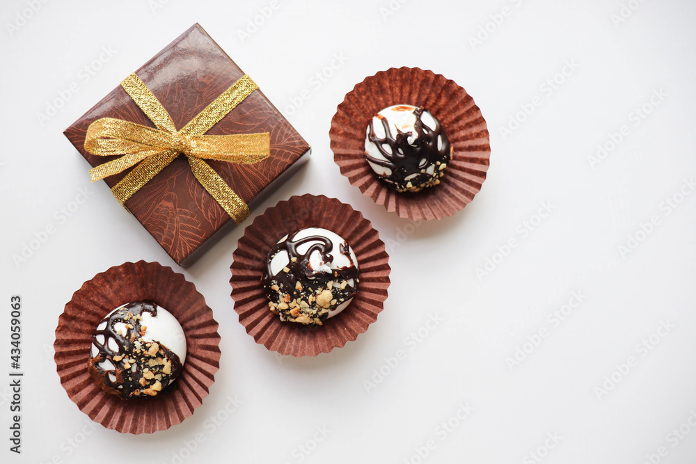 gift box on a white background and chocolate candies. space for text gift box on a white background and chocolate candies. space for text