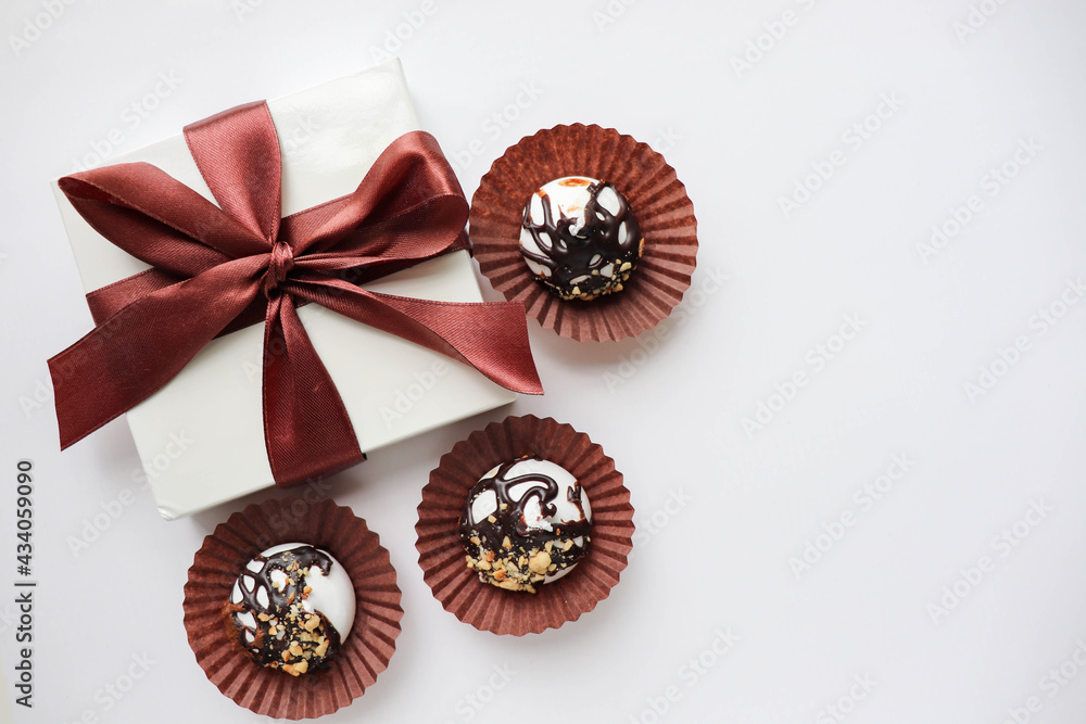 gift box on a white background and chocolate candies. space for text gift box on a white background and chocolate candies. space for text