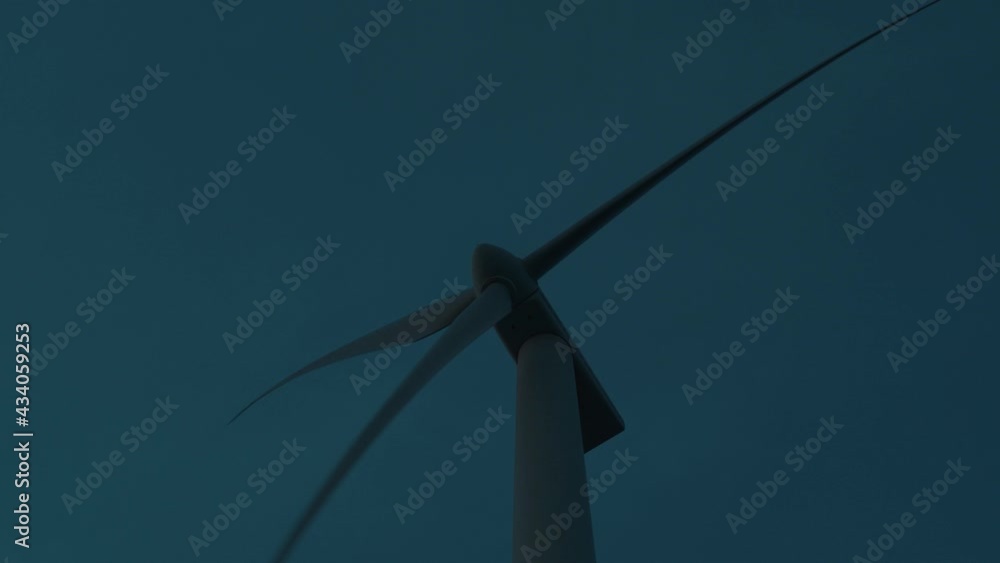 Huge spinning propeller blades of wind turbine on late sunset. Slow motion Huge spinning propeller blades of wind turbine on late sunset. Slow motion