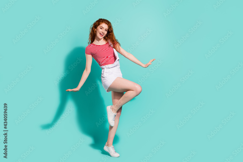 Full length body size view of nice pretty cheerful girl dancing posing having fun isolated bright blue color background Full length body size view of nice pretty cheerful girl dancing posing having fun isolated bright blue color background