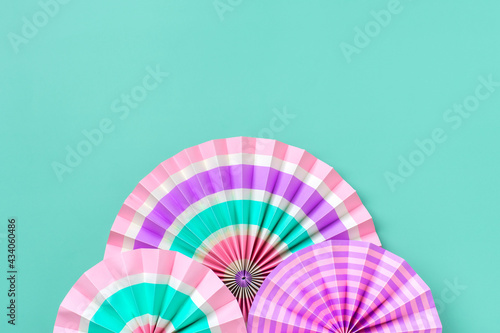 Traditional Japaneses festival paper fan with pink  turquoise  white stripes Birthday party  celebration holidays concept Abstract background