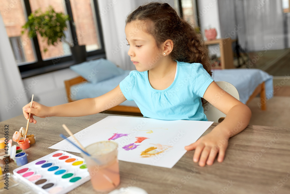 childhood, hobby and leisure concept - little girl drawing picture with colors and brush at home childhood, hobby and leisure concept - little girl drawing picture with colors and brush at home