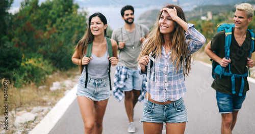 Group of backpackers and young friends traveling and having fun together