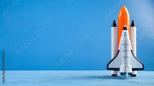 Fototapeta Naklejka Na Ścianę i Meble -  Toy space shuttle on blue background. Rocket launch