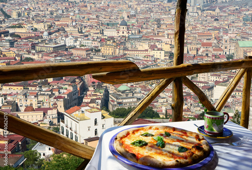 Fototapeta Naklejka Na Ścianę i Meble -        Italian pizza Margarita served on terrace with Naples view, Italy