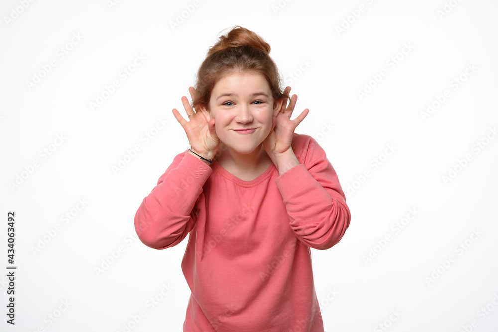 Studio portrait of cheerful young girl making funny face. White background Studio portrait of cheerful young girl making funny face. White background