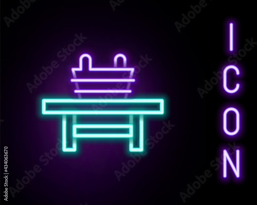 Glowing neon line Sauna bench with bucket icon isolated on black background. Colorful outline concept. Vector