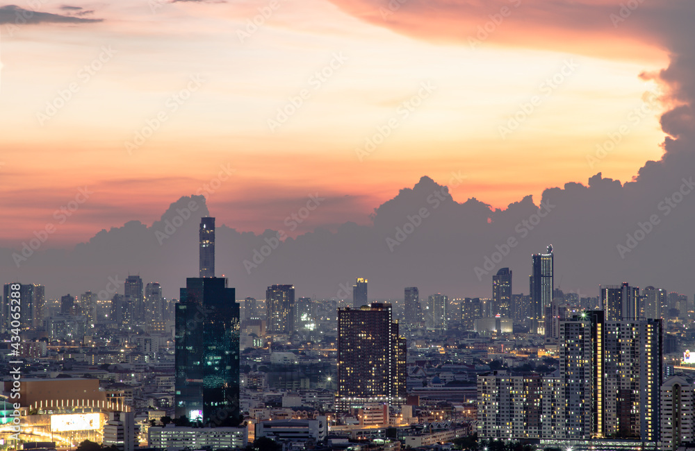Fototapeta premium Bangkok, Thailand - May 09, 2021: Aerial view of Beautiful scenery view of Skyscraper Evening time Sunset creates relaxing feeling for the rest of the day. Selective focus.