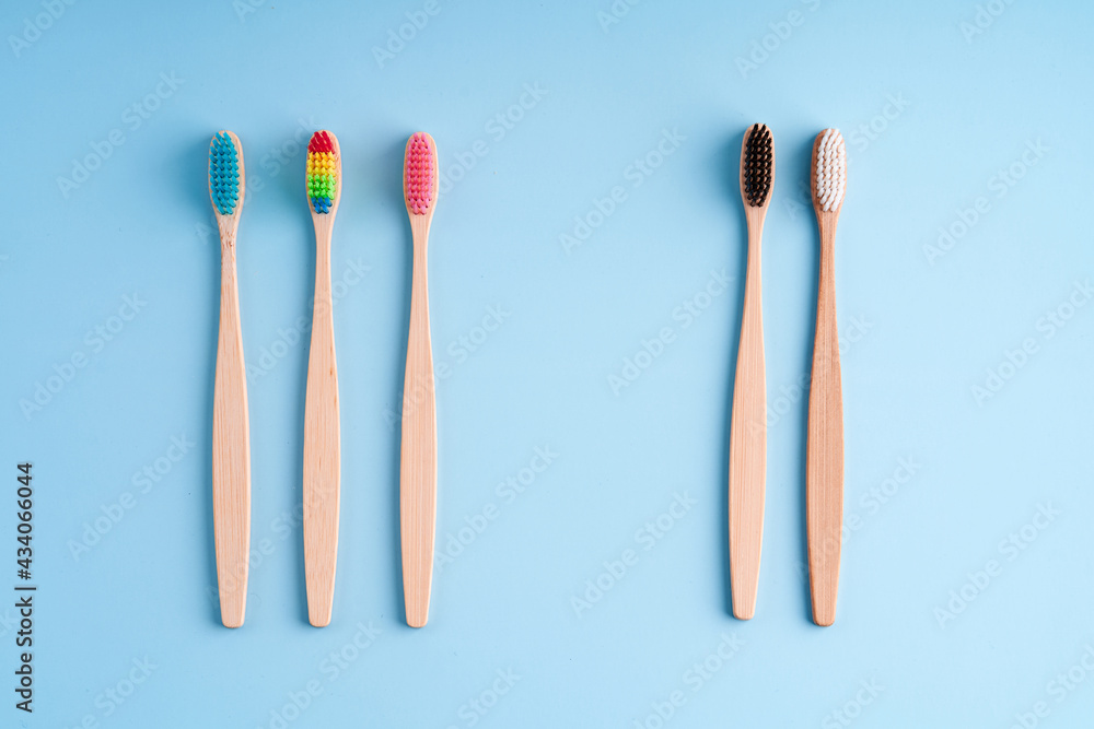 A bunch of eco-friendly bamboo toothbrushes. Global environmental trends. Gender and racial inequality. Toothbrushes of different genders A bunch of eco-friendly bamboo toothbrushes. Global environmental trends. Gender and racial inequality. Toothbrushes of different genders