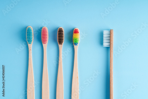 A bunch of eco-friendly bamboo toothbrushes. Global environmental trends. Gender and racial inequality. Toothbrushes of different genders