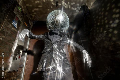 Mr disco ball dancing in a lift photo