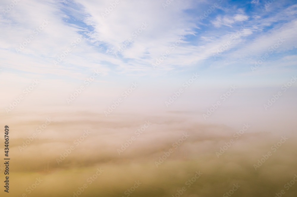 Breathtaking top view of the misty valley in the morning. Aerial photography, drone shot.