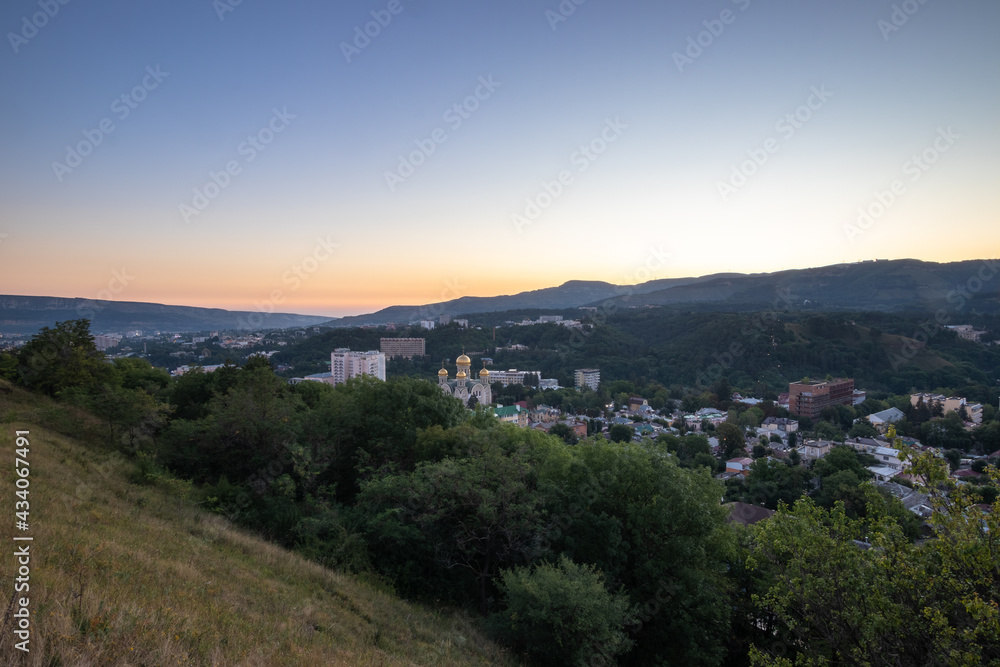 Sunrise over mountains and town Kislovodsk, morning dusk.