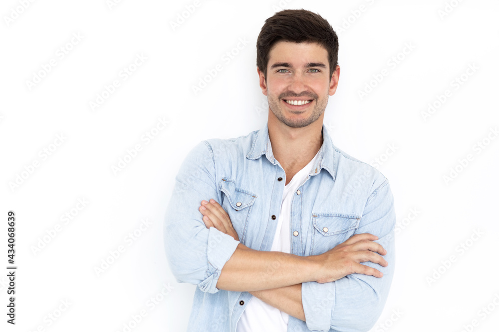 Сlose-up shot handsome self-assured cheerful male businessman has a wide smile crossed arms while wearing a fashionable denim shirt Сlose-up shot handsome self-assured cheerful male businessman has a wide smile crossed arms while wearing a fashionable denim shirt