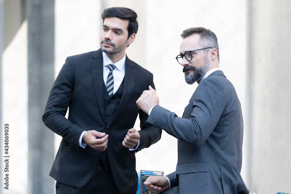 Business where a boss explaining the company strategy to his colleagues. Young businessman pointing fingers. Business where a boss explaining the company strategy to his colleagues. Young businessman pointing fingers.