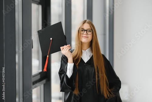 Educational theme: graduating student girl in an academic gown.