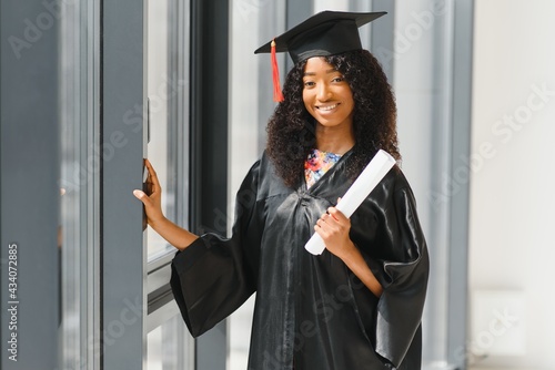 cheerful african american graduate student with diploma in her hand