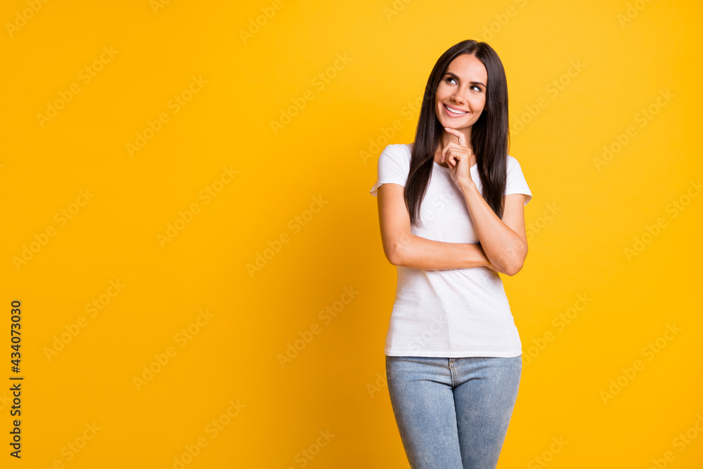 Photo portrait of woman wearing white outfit looking blank space touching chin isolated on vivid yellow color background Photo portrait of woman wearing white outfit looking blank space touching chin isolated on vivid yellow color background