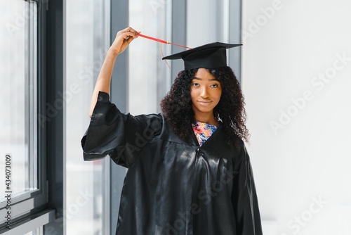 cheerful african american graduate student with diploma in her hand