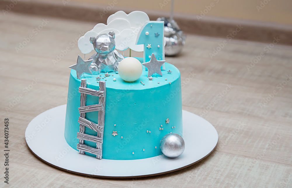 Birthday cake with light blue mirror glaze. Chocolate decor and number one. Birthday cake with light blue mirror glaze. Chocolate decor and number one.