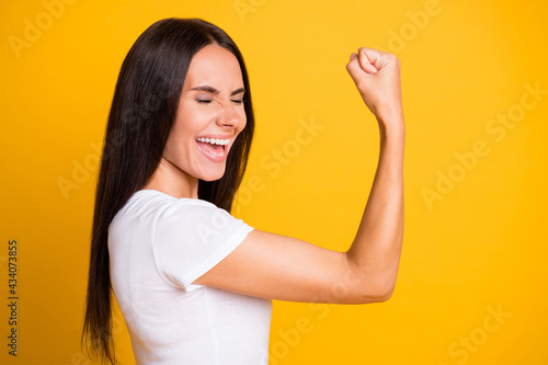 Photos Photo of sweet pretty young lady wear white t-shirt rising arm showing muscles l
