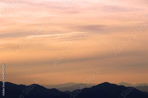 Sunset sky and silhouette mountains