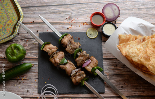 Adana Kebab, Turkish Kabab & Lebanoni Boti  served in a wooden cutting board isolated on wooden background side view
 photo