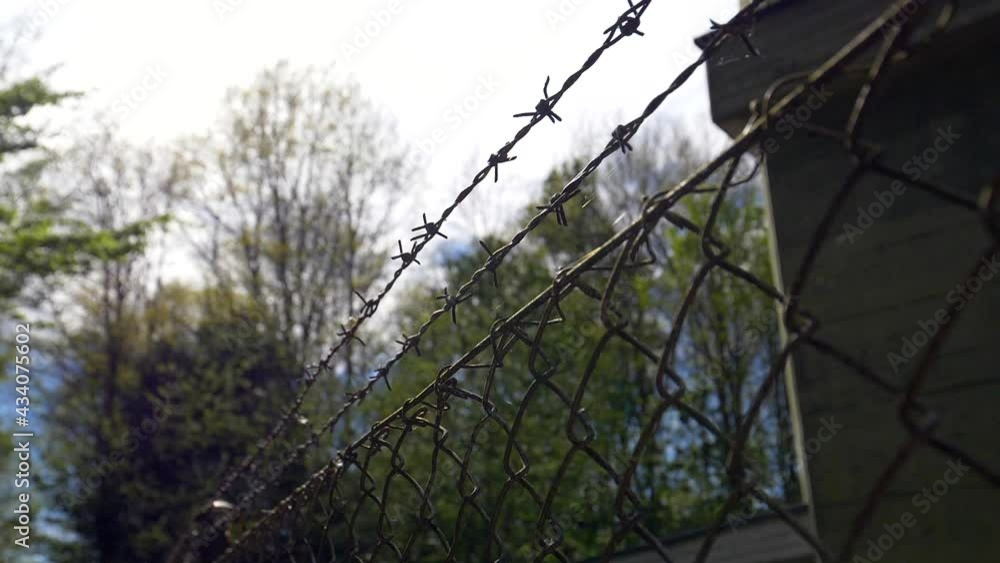 Dolly shot of fence with wire protection for military area in nature Dolly shot of fence with wire protection for military area in nature