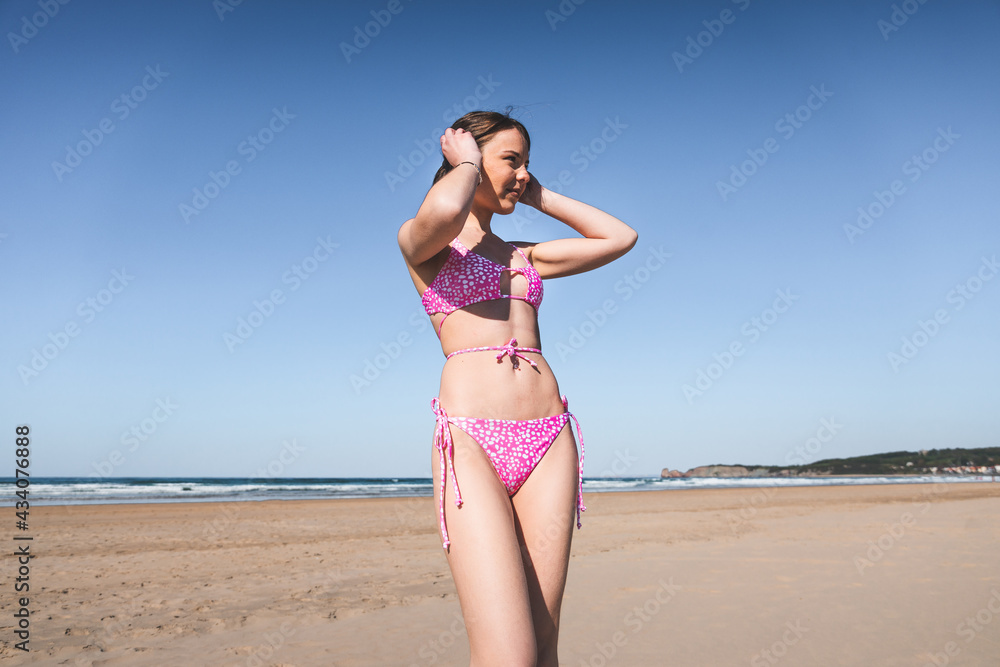 Young woman portrait with a pink bikini on the beach