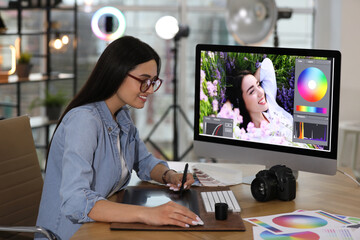 Professional retoucher working on computer in office