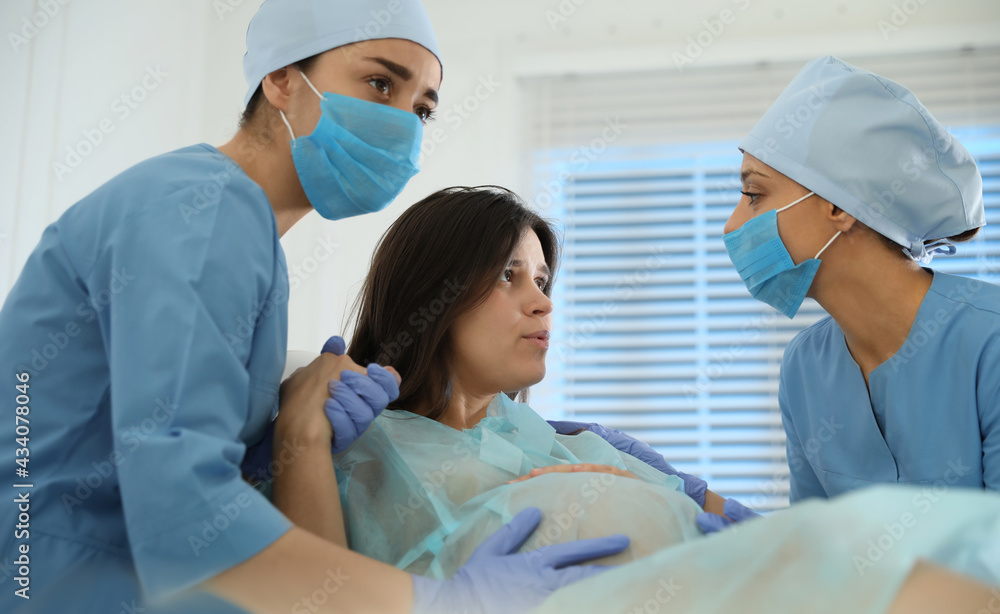 Woman giving child birth in maternity hospital Woman giving child birth in maternity hospital
