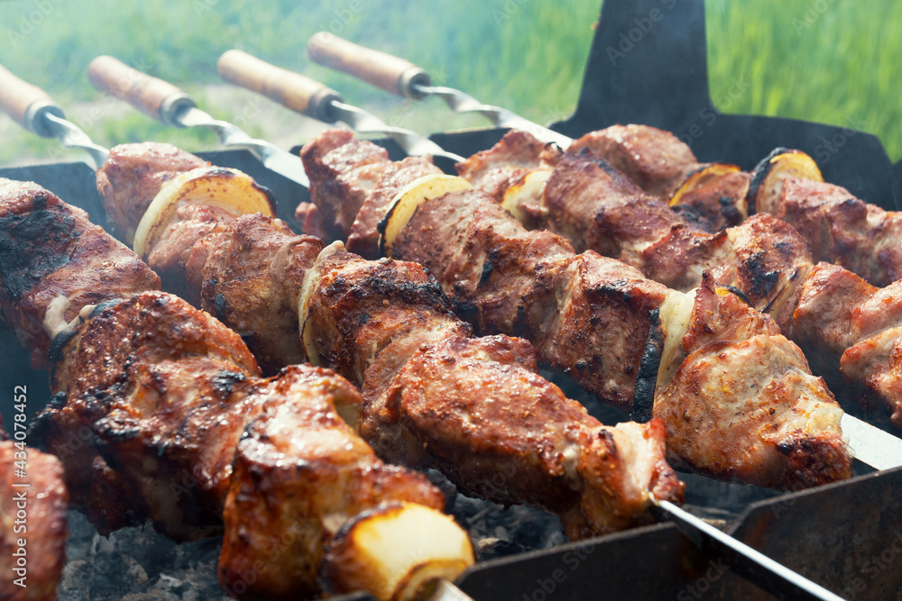 Marinated shashlik preparing on a barbecue grill over charcoal. Shashlik or Shish kebab popular in Eastern Europe. Shashlyk (skewered meat) was originally made of lamb. Roast Beef Kebabs On BBQ Grill. Marinated shashlik preparing on a barbecue grill over charcoal. Shashlik or Shish kebab popular in Eastern Europe. Shashlyk (skewered meat) was originally made of lamb. Roast Beef Kebabs On BBQ Grill.