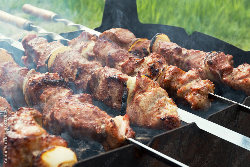Marinated shashlik preparing on a barbecue grill over charcoal. Shashlik or Shish kebab popular in Eastern Europe. Shashlyk (skewered meat) was originally made of lamb. Roast Beef Kebabs On BBQ Grill. Marinated shashlik preparing on a barbecue grill over charcoal. Shashlik or Shish kebab popular in Eastern Europe. Shashlyk (skewered meat) was originally made of lamb. Roast Beef Kebabs On BBQ Grill.