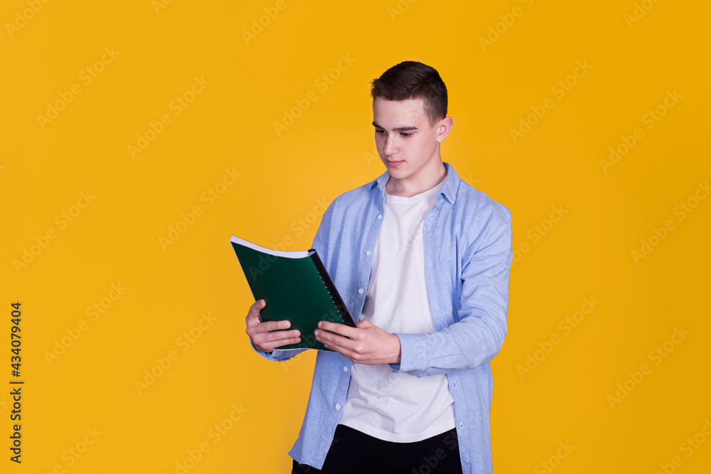 A handsome guy in a blue shirt  on a yellow background