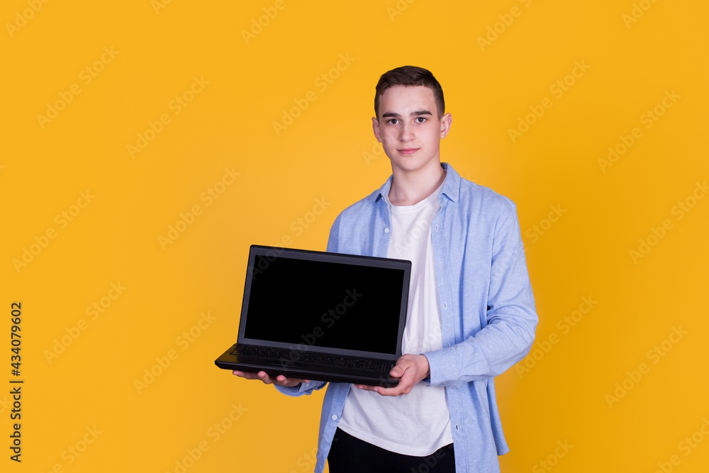 A handsome guy in a blue shirt on a yellow background A handsome guy in a blue shirt on a yellow background