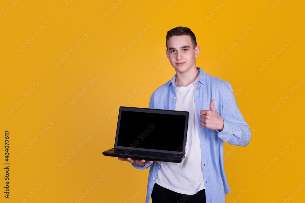 A handsome guy in a blue shirt on a yellow background A handsome guy in a blue shirt on a yellow background