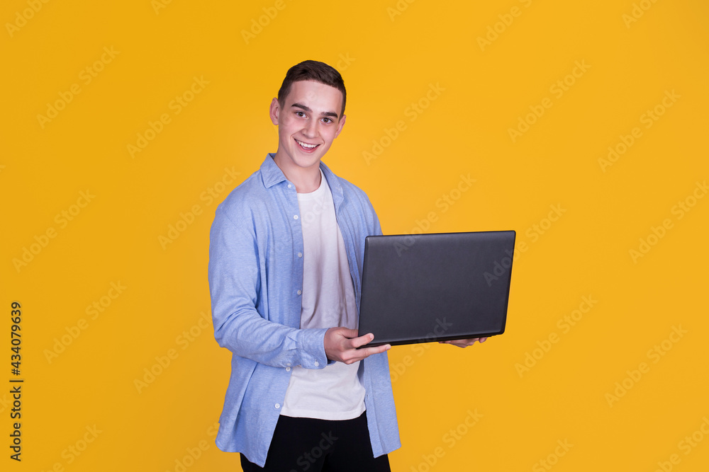 A handsome guy in a blue shirt on a yellow background A handsome guy in a blue shirt on a yellow background