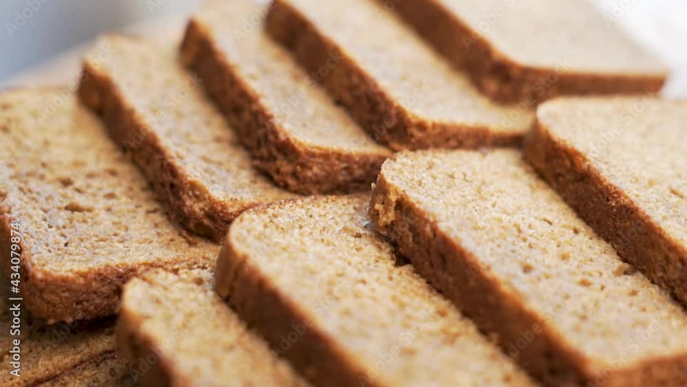 Sliced Black Rye Bread for Toast Sandwiches for Breakfast. Fresh Slices of Black Bread on A Wooden Tray, Close-up. Healthy Vegetarian Food. Sliced Black Rye Bread for Toast Sandwiches for Breakfast. Fresh Slices of Black Bread on A Wooden Tray, Close-up. Healthy Vegetarian Food.